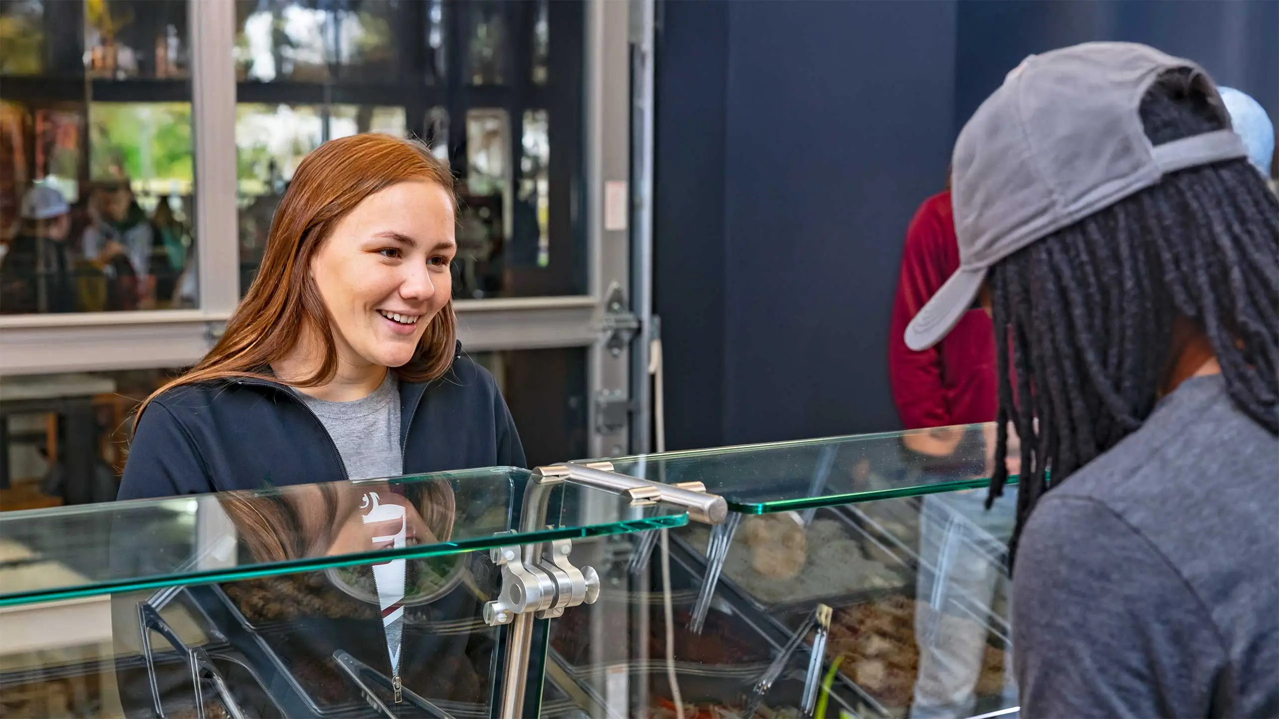 Student happily waiting while food is being prepared